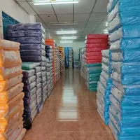 Stocked fabric rolls in popular colours at a fabric wholesaler warehouse
