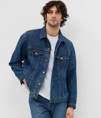 A man wearing a trendy dark blue colour denim jacket on top of a comfortable white t shirt