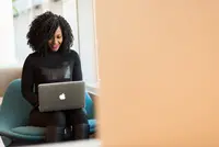 A background image showing a lady contacting someone through her laptop