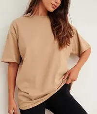 A woman wearing a trendy oversized t shirt in beige colour