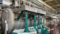 A modern fabric dyeing machine with large quantities of dyed fabric