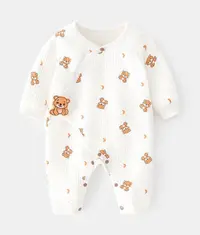 A cute white coloured baby onesie with teddy bear pattern printed all over