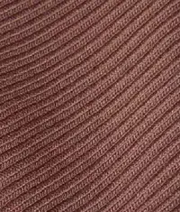 A close up image of a dull red colour rib knit fabric roll